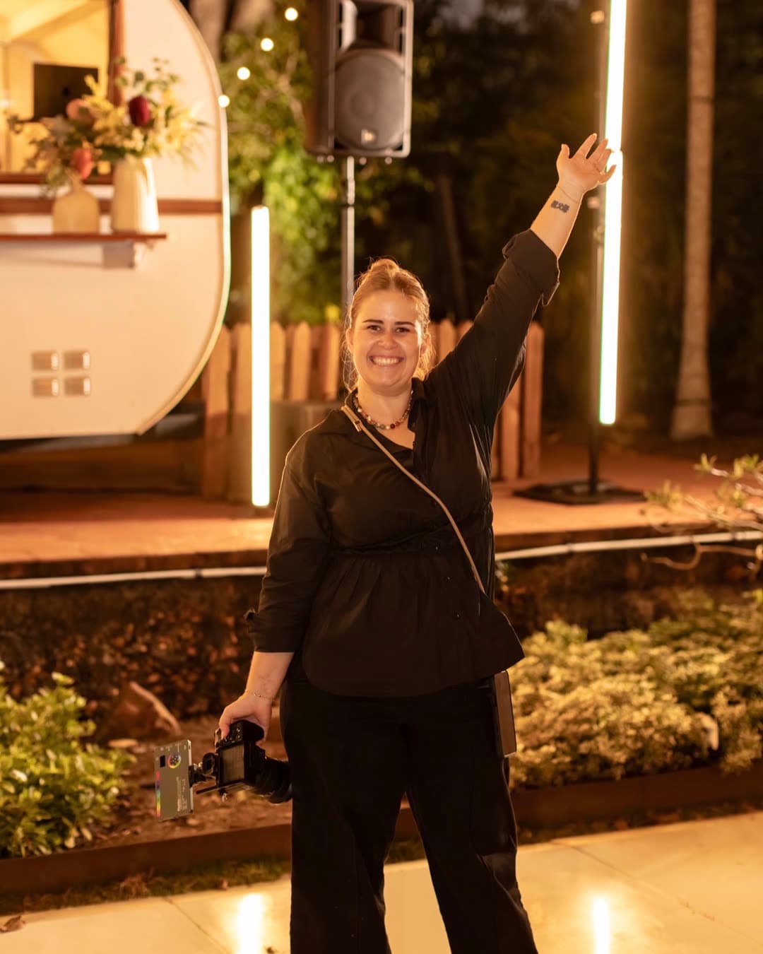 Tarsh at a wedding reception with her camera